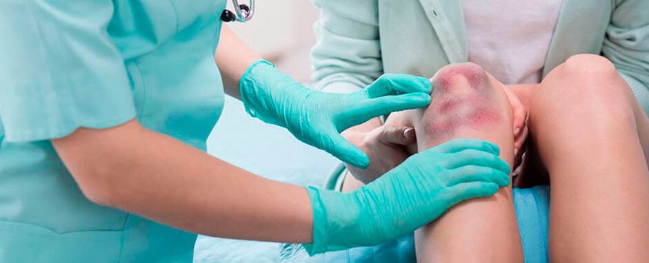 Un médecin examine une blessure au genou